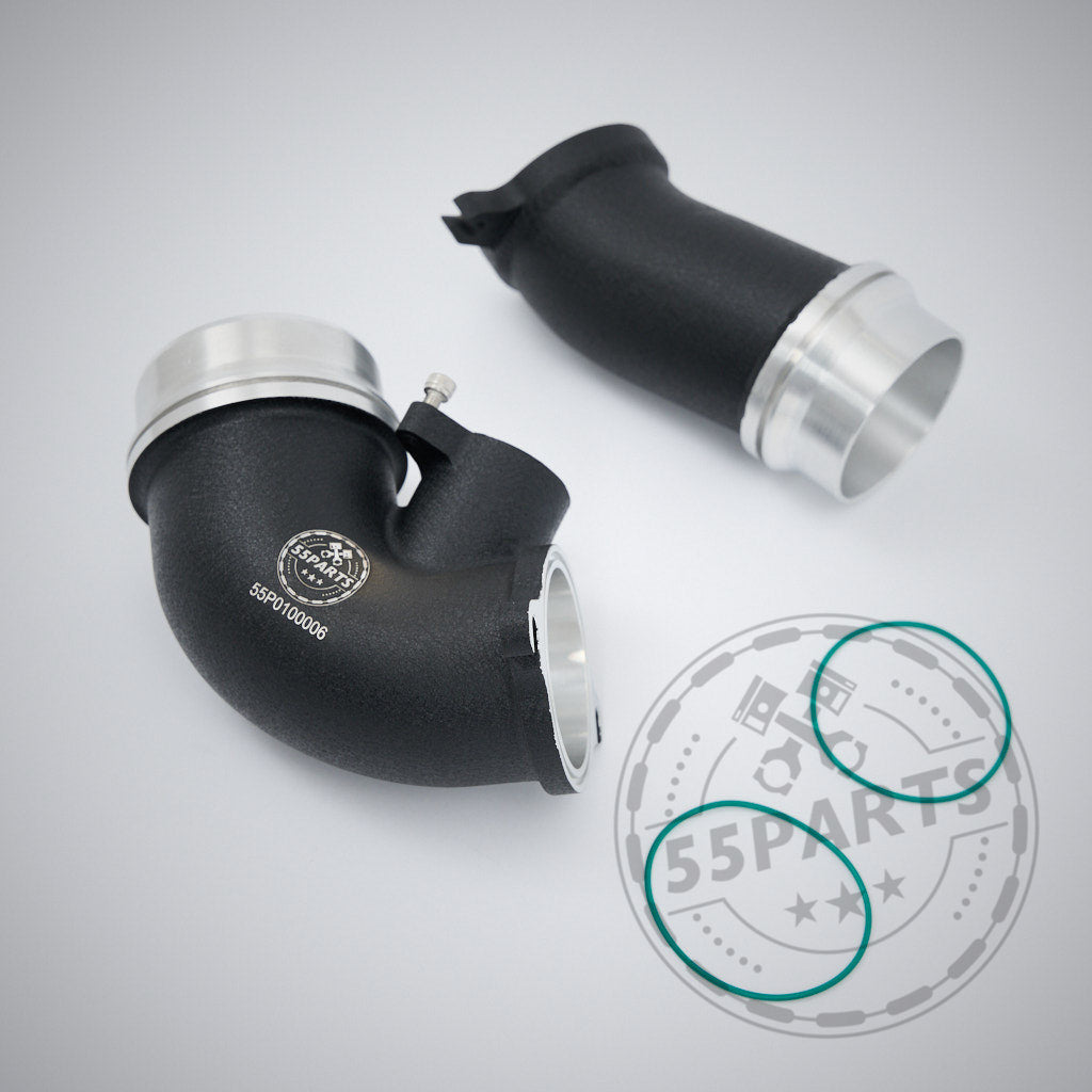 Zwei schwarze 55Parts High Flow Turbo Ansaugrohre für BMW G87 M2, G80 G81 M3 und G82 G83 M4 S58 mit silbernen Enden und zwei grünen O-Ringen sind auf hellgrauem Hintergrund abgebildet.