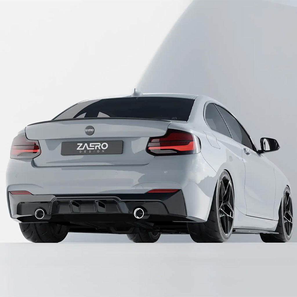 Ein silberner Sportwagen mit schwarzen Felgen und Doppelauspuff ist mit einem ZAERO Design EVO-1 Diffusor passend für BMW F22, F23 M235i, M240i von ZAERO von hinten vor weißem Hintergrund dargestellt.